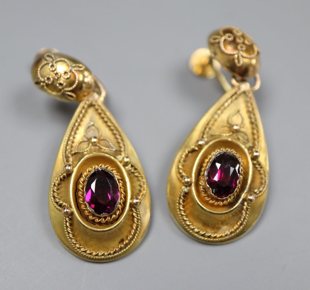 A pair of Victorian yellow metal and garnet set pear shaped drop ear clips, 38mm, gross 5.7 grams.